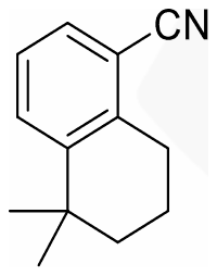 Tetralin with CN on the aromatic ring and a gem-dimethyl group on the saturated ring carbon next to the benzene ring, drawn on the side away from CN